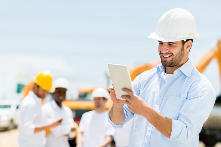 Male engineer at a construction site with a tablet computer